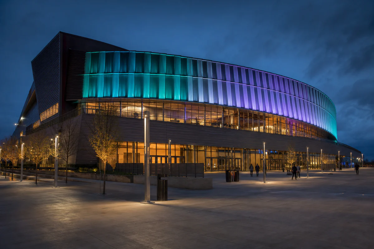 Modern sports arena with programmable teal and violet facade lighting